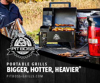 A man cooking chicken and other meats on a Pit Boss portable grill outside in the back of a truck.