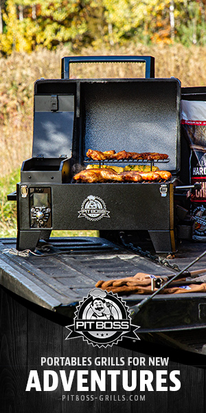 Sausages and chicken cooking outside on a Pit Boss portable charcoal grill.